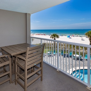 Enjoy stunning beachfront views from this balcony with a stylish poly-wood dining set, perfect for relaxing meals outdoors