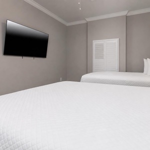 Picture yourself unwinding on crisp bedding, closing the shutters, and watching a movie in this queen guest suite