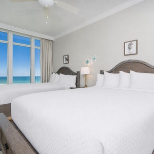 Admire seahorse art above two queen beds while watching the gulf meet the beach through the windows