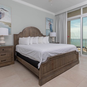 Retreat to the king master suite with cozy bedding and drift off to the sound of the waves from the balcony