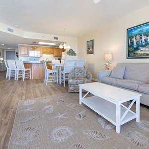 Relax in the spacious living area featuring a comfortable sofa with queen sleeper, a charming rug, and a dining space
