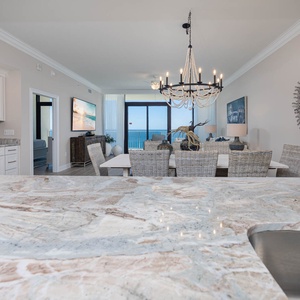 Gaze at the inviting dining area with a stylish chandelier and enjoy the view from the spacious kitchen countertop