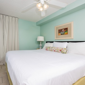 Experience restful nights in this inviting bedroom suite with a plush king bed, soft linens, and a mounted TV