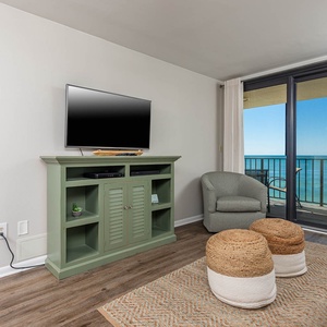 Cozy living area with a TV, inviting seating, queen sofa-sleeper, and breathtaking beach views