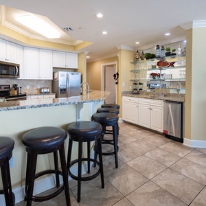 Kitchen with granite countertops, stainless appliances, and stylish seating for a perfect vacation gathering