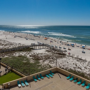 Breathtaking view of the serene beach and turquoise waters, perfect for relaxing under the sun from your private balcony
