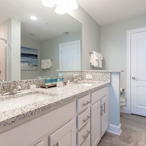 Freshen up at the dual-sink vanity, step into the glass shower, or soak in the soothing tub