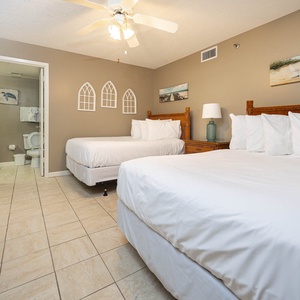 Relax in the guest bedroom featuring two double beds, tasteful decor, and a serene vibe for restful nights