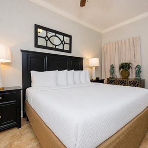 Experience restful nights in this serene guest suite, where fluffy king bedding invites you to unwind after a day at the coast