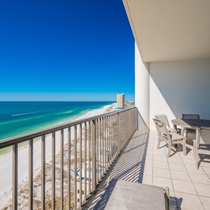 This balcony features a dining set with a stunning beachfront view, perfect for relaxing meals outdoors
