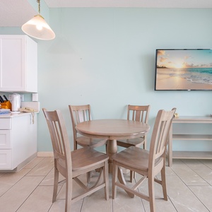 Enjoy meals in this cheerful kitchen featuring white cabinets and accessible features for guests with limited mobility