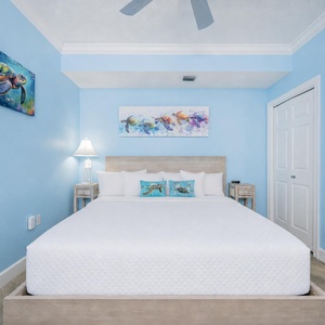 Drift into restful sleep surrounded by soft textures and vibrant coastal artwork in this king guest suite