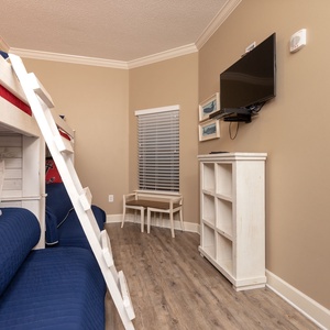 Climb into cozy twin bunk beds for adventurous sleepovers in this charming bunk room, with a TV ready for movie nights
