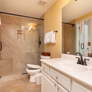 Refresh in the guest bathroom featuring a spacious vanity, elegant fixtures, and a glass-enclosed walk-in shower