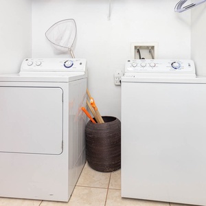The laundry area features a stacked washer and dryer, providing convenience for guests during their stay