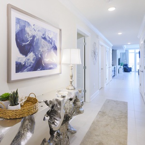 Step into the bright foyer, admire the sculpted console, and feel the welcoming vibe to this coastal retreat