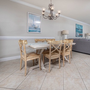 Gather around the rustic dining table, enjoying meals with a view of the beach through large windows