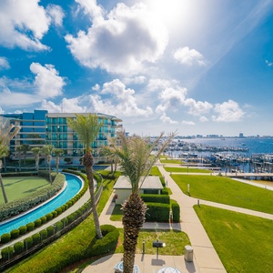 Soak in the coastal ambiance as you wander through lush grounds, embracing the gentle breeze and waterfront views