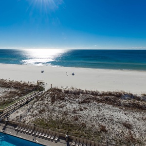 Gaze at the tranquil waters and beach from your balcony, perfect for unwinding under the sun