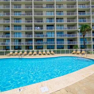Relax by the pool with palm trees and a stunning beachfront view from the serene setting at Seaside Beach & Racquet Club