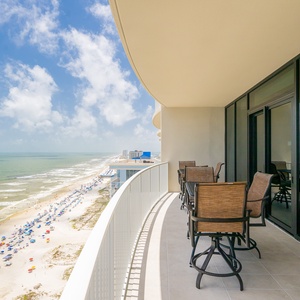 Enjoy your favorite drink at the balcony table while enjoying expansive views of the sparkling water and blue skies