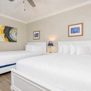 Snuggle up in the inviting queen beds, where soft bedding invites comfort for restful nights in this guest room