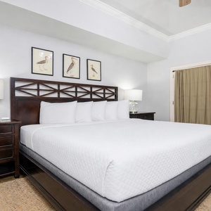 Unwind after a day at the beach in this elegant king master suite surrounded by stylish coastal accents