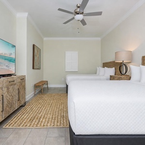 Unwind in this queen suite two comfortable beds, a large TV, and fluffy pillows