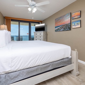 The master bedroom features a king bed, a TV for entertainment, and a breathtaking view from the balcony