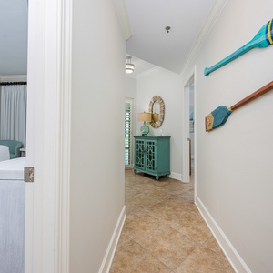 Step into a welcoming hallway featuring coastal decor, a stylish console, and natural light streaming through the windows