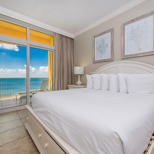 Enjoy restful nights in the inviting master bedroom, featuring a king bed and stunning beachfront balcony views