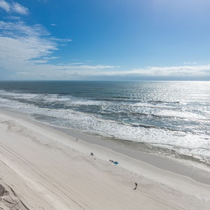 Relax with a beachfront view that showcases the sparkling waves and soft white sand, perfect for a relaxing getaway