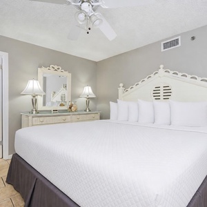 Cream tones and gentle light create a soothing atmosphere in the guest suite with a plush king bed