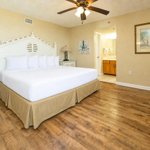 Bright master suite with a king bed invites restful nights and peaceful mornings during your vacation stay