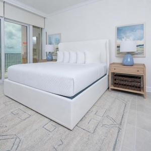 Retreat to the king master suite with cozy bedding and drift off to the sound of the waves from the balcony