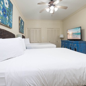 Rest in this inviting guest room with two comfortable queen beds, colorful art, and a TV for entertainment during your stay
