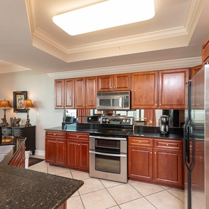 Prepare meals in this kitchen with elegant cabinetry, stainless appliances, and spacious countertops