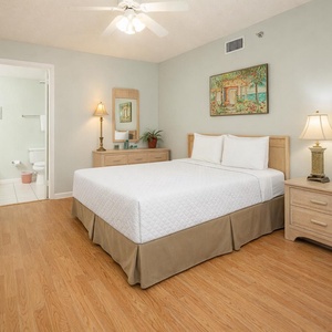 Feel refreshed in this inviting queen guest suite, where soft bedding await you after a beach day