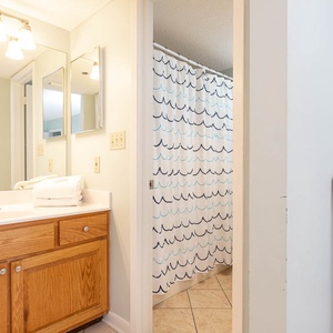 Refresh in the master bathroom featuring a spacious vanity, modern lighting, and a shower area