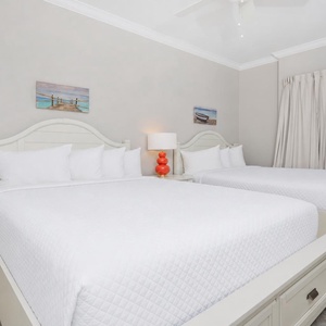 Settle into one of the roomy queen beds in this guest suite with coastal accents
