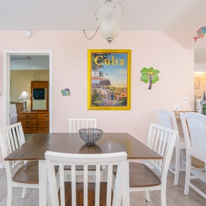 Sit together at the dining table, enjoying friendly conversation amidst colorful beach-themed decor