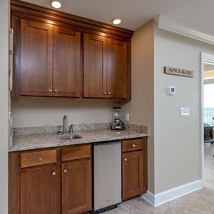 Grab a chilled drink from the fridge or create your favorite cocktail at the wet bar with elegant glassware displays