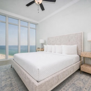 Relax on the cozy king bed in this guest suite and enjoy a colorful sunrise through the windows