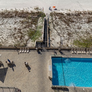 Relax by the inviting pool, with lounge chairs nearby and easy access to the beach just steps away