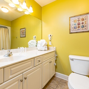 Bright guest bath lets you refresh with crisp towels and warm water after a fun day along the coast