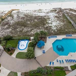 Dive into relaxation at the inviting pool area, complete with lounge chairs and a fun splash zone for all ages