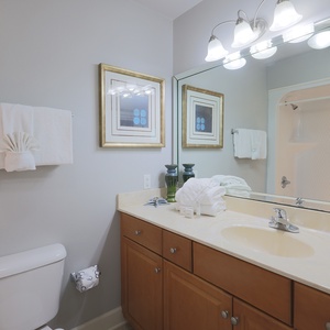 Freshen up in this guest bath in the relaxing shower or soothing tub before an exciting beach day