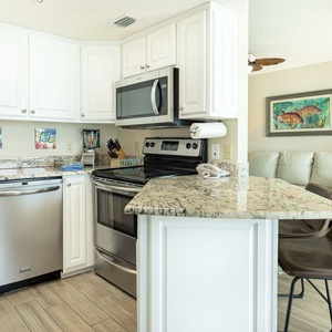 Smooth granite breakfast bar seats you for casual chats while meals simmer on the stove in your kitchen