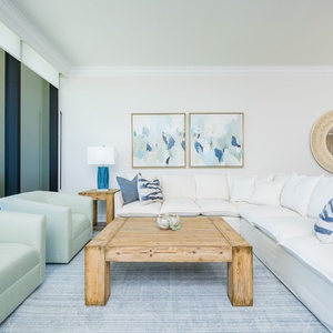 Unwind on the plush sectional sofa with a beachfront view, perfect for relaxation and conversation