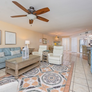 Enjoy cozy conversations in plush seating while soaking in the inviting coastal vibe of this living space